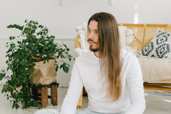 Man meditating in a calm, well-lit room, symbolizing peace of mind.